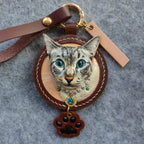 Custom-made luxury leather pet keepsakes and gifts featuring pet portraits, including cat and dog keychains.