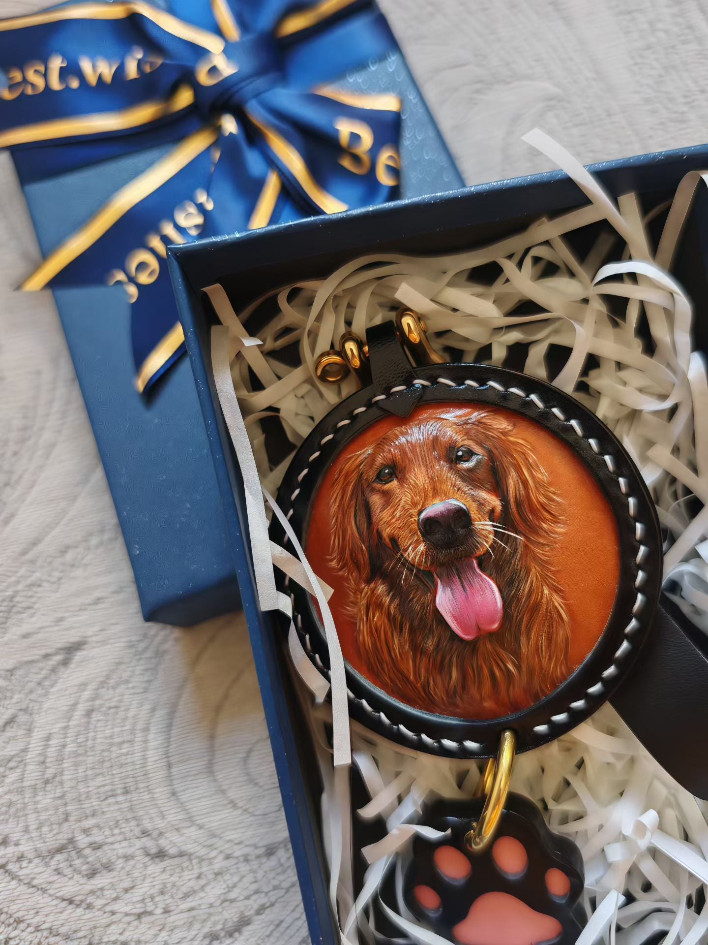 Custom-made luxury leather pet keepsakes and gifts featuring pet portraits, including cat and dog keychains.