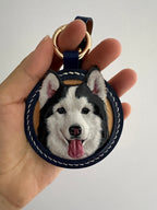 Custom-made luxury leather pet keepsakes and gifts featuring pet portraits, including cat and dog keychains.