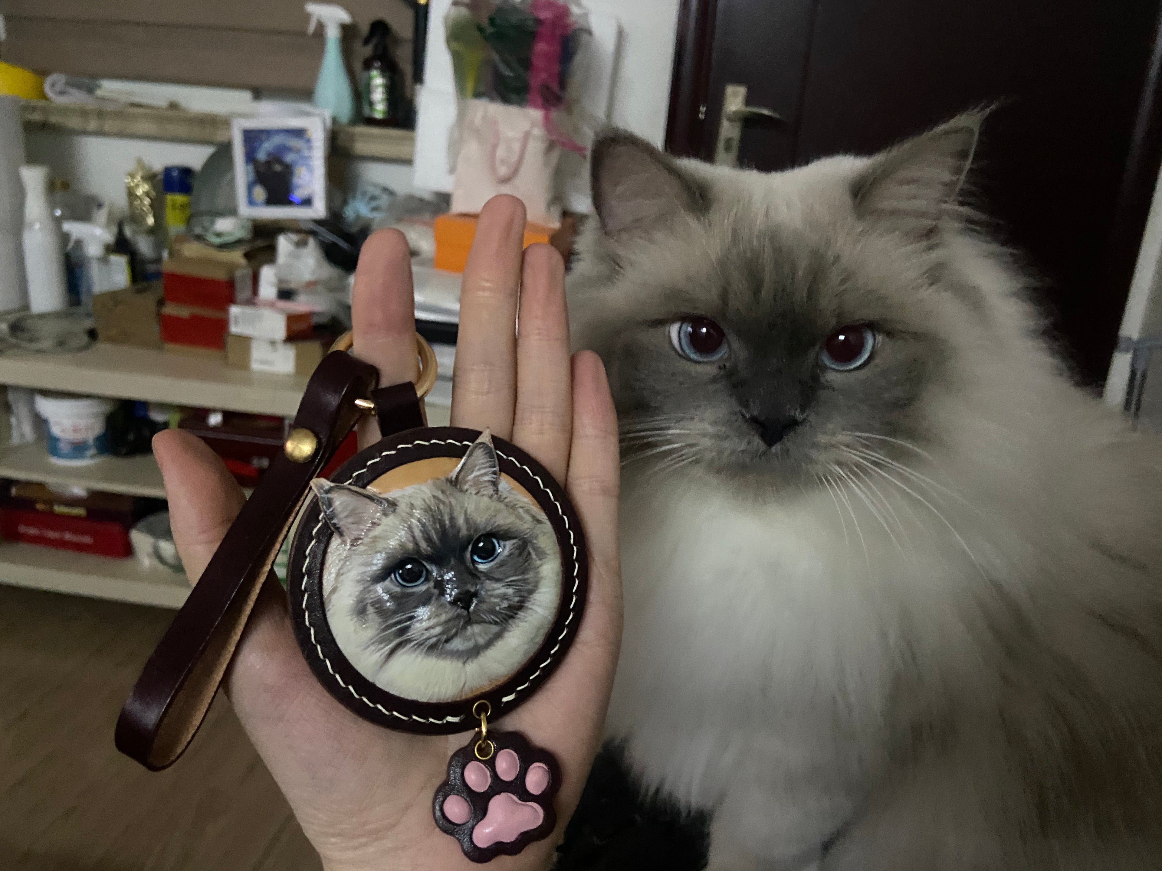 Custom-made luxury leather pet keepsakes and gifts featuring pet portraits, including cat and dog keychains.